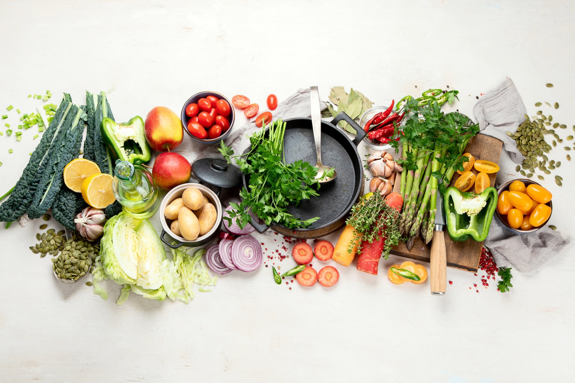 Healthy food clean eating selection: fruit, vegetable, seeds, superfood, cereal, leaf vegetable on a white background. Top view.
